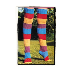 May include: A pair of colorful striped knee-high socks in shades of red, yellow, blue, and purple. The socks are made of a soft, knitted fabric and are perfect for adding a pop of color to any outfit.