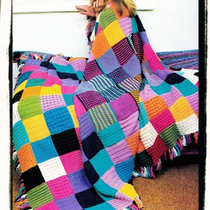May include: A colorful crocheted blanket with fringe, featuring a patchwork design of squares in various colors, including pink, blue, green, yellow, orange, and purple.
