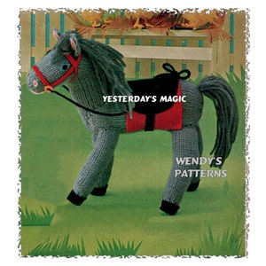 May include: Knitting pattern for a gray horse with a red and black saddle. The pattern is from "Yesterday's Magic" and "Wendy's Patterns".