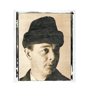 May include: A black and white photograph of a man wearing a black hat. The man is looking to the right of the photograph. The photograph has a faded, vintage look.