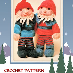 May include: A vintage image of two crocheted Santa's helpers. One is wearing blue and black, the other red and blue. Both have red hats, white beards, and are standing close together. The image is framed with a blue background, snowflakes, and Christmas trees. The text reads "CROCHET PATTERN to make SANTAS HELPERS."