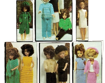 May include: A collection of knitted doll clothes in various colors and styles, including dresses, skirts, pants, sweaters, and jackets. The clothes are designed for dolls with a similar size and shape.