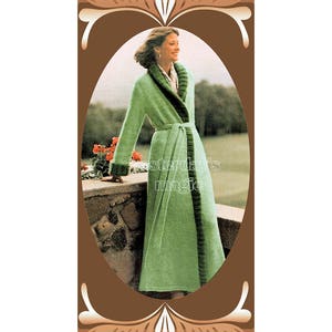 May include: A green knitted robe with a brown fur collar and trim. The robe is belted at the waist and has long sleeves. The model is standing in a garden setting.