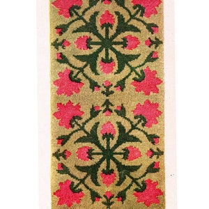May include: A rug design with a repeating pattern of pink flowers and green leaves on a beige background. The pattern makes a charming scatter rug that is 30 inches by 61 inches.