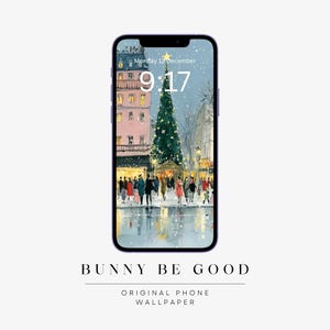May include: A smartphone displays a winter scene with a Christmas tree, buildings, and people. The time is 9:17 AM on Monday, December 12th. The phone is purple and the text "BUNNY BE GOOD" is at the bottom.