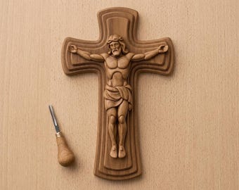 May include: A wooden crucifix with a detailed carving of Jesus Christ, displayed on a light-colored wooden surface. The image includes a carving tool. Text at the top reads "CNC & 3D PRINT READY" and at the bottom "Crucifix Cross 3D Relief STL".