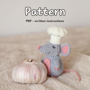 May include: A crocheted gray mouse wearing a chef's hat, with pink ears and belly, next to a bulb of garlic. The image includes the text "Pattern" and "PDF - written instructions".
