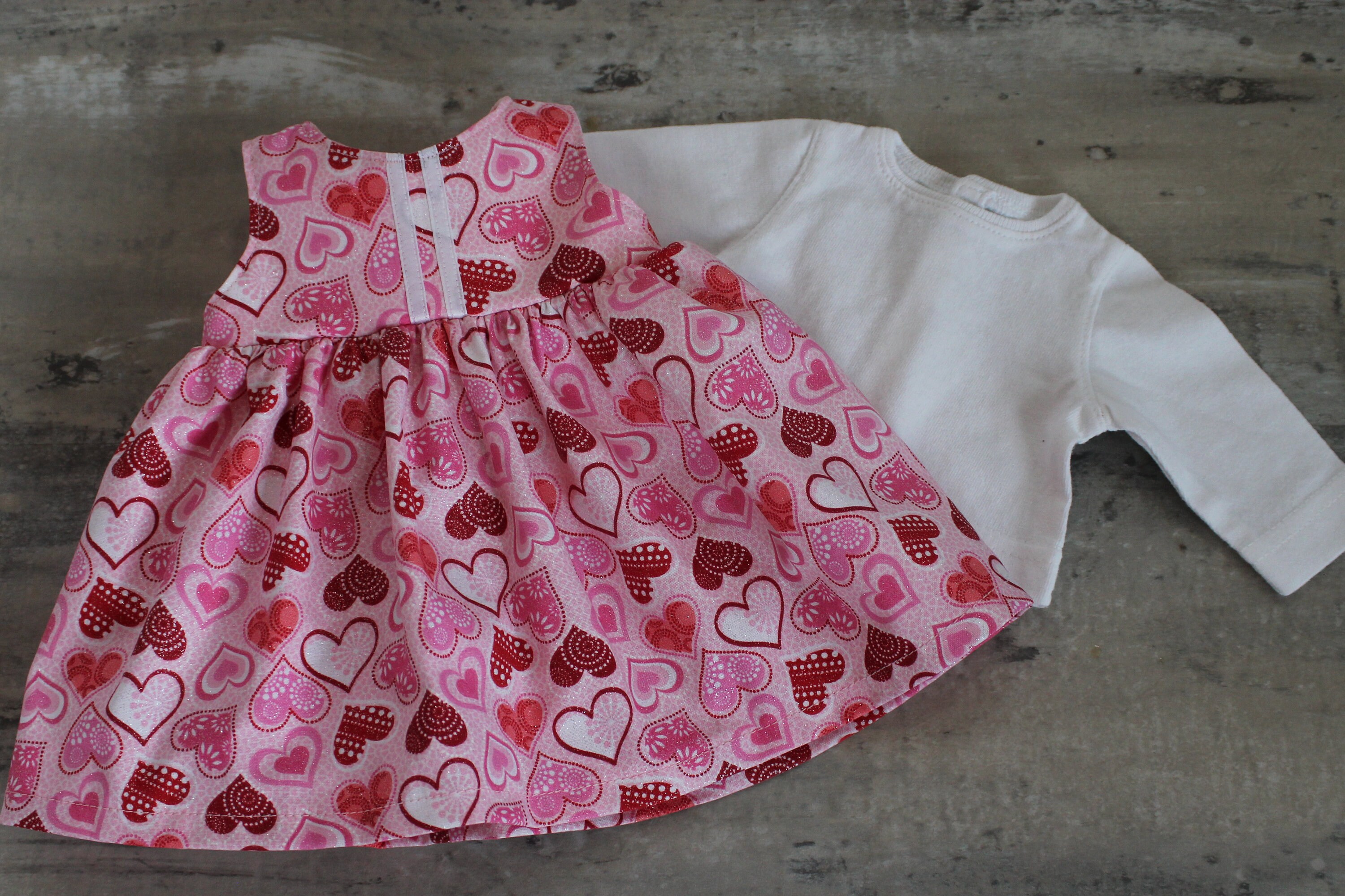 pink jumper with red hearts