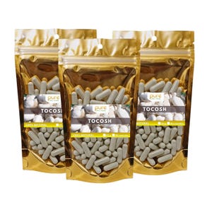 May include: Three gold foil pouches filled with gray capsules. Each pouch has a white label with the text "pure", "TOCOSH", and "100% NATURAL". The capsules are displayed against a background of white stones.