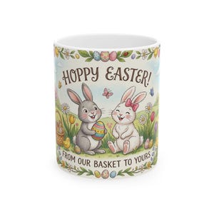 May include: A white ceramic mug with a black handle and the text "But First, Coffee" in a bold, black font. The mug is set against a blurred background, suggesting a cosy setting.