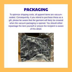 May include: A black garment vacuum-sealed in clear plastic packaging. The text "dead inside but still sparkling" is embroidered or printed on the fabric, which appears creased due to the vacuum compression process used for shipping.