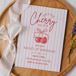May include: A birthday invitation with a pink and white striped design. The text "She's the Cherry on Top" is written in red script above a watercolor illustration of cherries. The invitation includes details for Katie's 21st birthday.