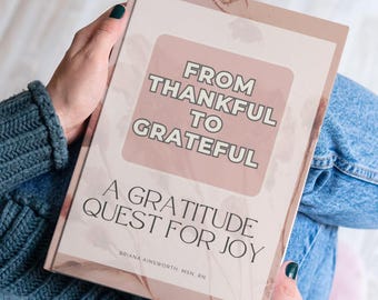 May include: A journal titled "From Thankful to Grateful: A Gratitude Quest for Joy." The cover is a soft pink with a floral design and the title in a white, bold font. The author's name, Briana Ainsworth, MSN, RN, is at the bottom.