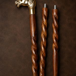 May include: A three-piece walking stick featuring a polished brass horse head handle and a dark brown wooden shaft with a spiral twist design. The segments connect via threaded metal hardware, and the base includes a black rubber tip for stability.