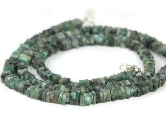 May include: A strand of emerald green gemstone beads, each bead is a rectangular shape. The beads are strung on a silver chain.