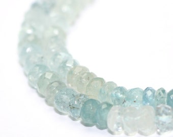 May include: A strand of light blue aquamarine beads, with a graduated color from light to dark blue.