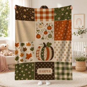 May include: A rectangular throw blanket featuring a patchwork design with autumn-themed patterns including orange and white buffalo check, brown floral prints, green daisy motifs, falling maple leaves, and a central pumpkin graphic labeled HARPER.