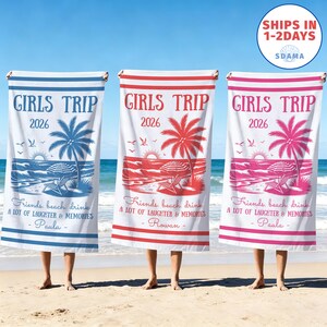May include: Three white beach towels with "GIRLS TRIP 2026" printed on them. Each towel features a beach scene with a palm tree, umbrella, and text: "Friends, beach, drink, A LOT OF LAUGHTER & MEMORIES" and a name. One towel is blue, one red, and one pink.