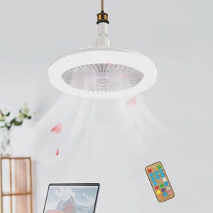 May include: A white circular ceiling fan with an integrated LED light fixture, featuring a central fan blade assembly and a smooth outer ring. The unit includes a small handheld remote control with multiple coloured buttons for light and fan settings.