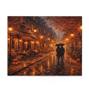 May include: An autumn scene of a cobblestone street in a European city. A couple walks under an umbrella. The street is lined with buildings, trees with orange leaves, and lit street lamps. Pumpkins and outdoor seating are visible.