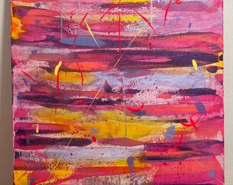 May include: Abstract canvas painting with a vibrant colour palette. The artwork features horizontal brushstrokes in shades of pink, red, orange, and yellow, with splashes of purple and yellow accents. The canvas is displayed on a small wooden easel.