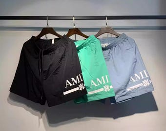 Bañador corto con estampado del logotipo de Amiri en negro, verde y azul claro, ropa de baño urbana de lujo