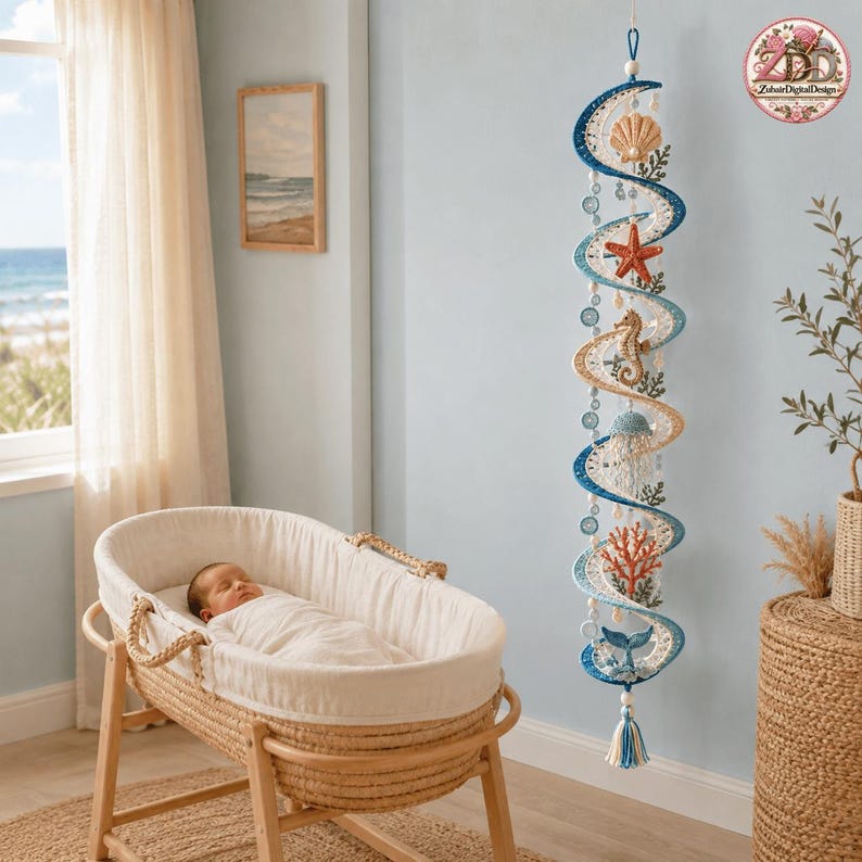 May include: A vertical hanging mobile featuring a spiral design in shades of blue and cream, decorated with crocheted sea life elements including a seashell, starfish, seahorse, jellyfish, coral, and a whale tail, finished with a tassel at the bottom.
