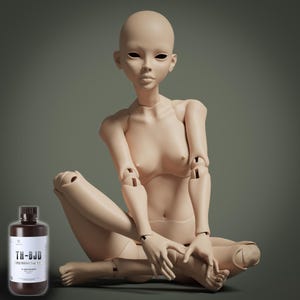 May include: A nude-colored ball-jointed doll (BJD) sits cross-legged, with articulated joints. A bottle of TH-BJD resin is in the lower left corner. The doll has a smooth, matte finish and is posed with hands clasped. The background is a muted green.