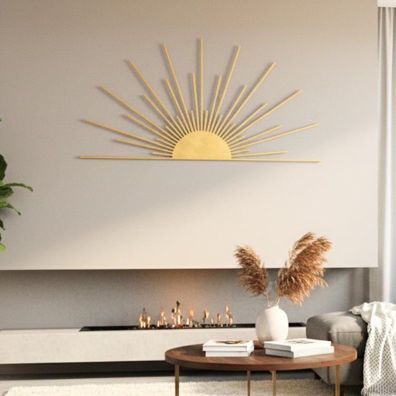 Golden metal sunburst wall art mounted in a modern living room