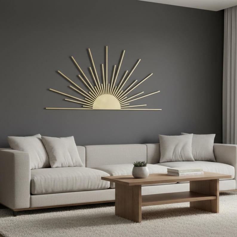 Golden metal sun wall art with warm LED backlight on a dark wall