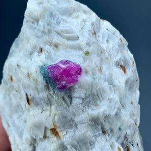 May include: A set of three ceramic mugs with a speckled, matte finish. The mugs are in shades of cream, light gray, and dark gray. Each mug has a simple, minimalist design, perfect for coffee or tea.