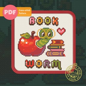 May include: Cross-stitch pattern featuring a red apple with a green worm wearing glasses, stacked books, and the words "BOOK WORM." The design includes a pink heart and the text "PDF Cross-stitch Pattern."