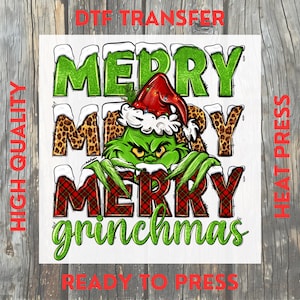 May include: A DTF transfer featuring a green Grinch character wearing a Santa hat, with the words "MERRY GRINCHMAS" in green, leopard print, and red plaid. The words "HIGH QUALITY" and "READY TO PRESS" are also visible.