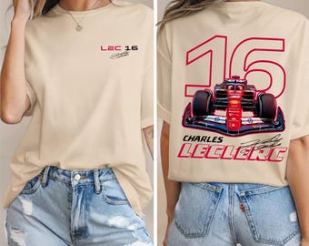 May include: Sand-colored t-shirt with the text "LEC 16" on the front. The back of the shirt features a red and black race car design with the number "16" and the name "CHARLES LECLERC".