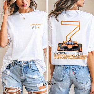 May include: White t-shirt featuring the name "Lundgaard" and the letter "A" with an arrow on the front. The back of the shirt displays the number "7" and a race car graphic, along with the name "Christian Lundgaard".
