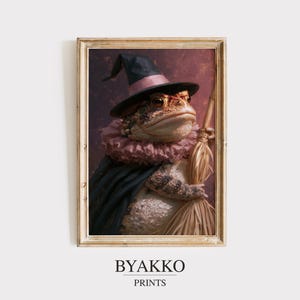 May include: A framed wall art print featuring a toad wearing a black witch hat with a pink band, a pink ruffled collar, and a dark cape, holding a wooden broomstick. The background is a dark, mottled purple. The text BYAKKO PRINTS appears below.
