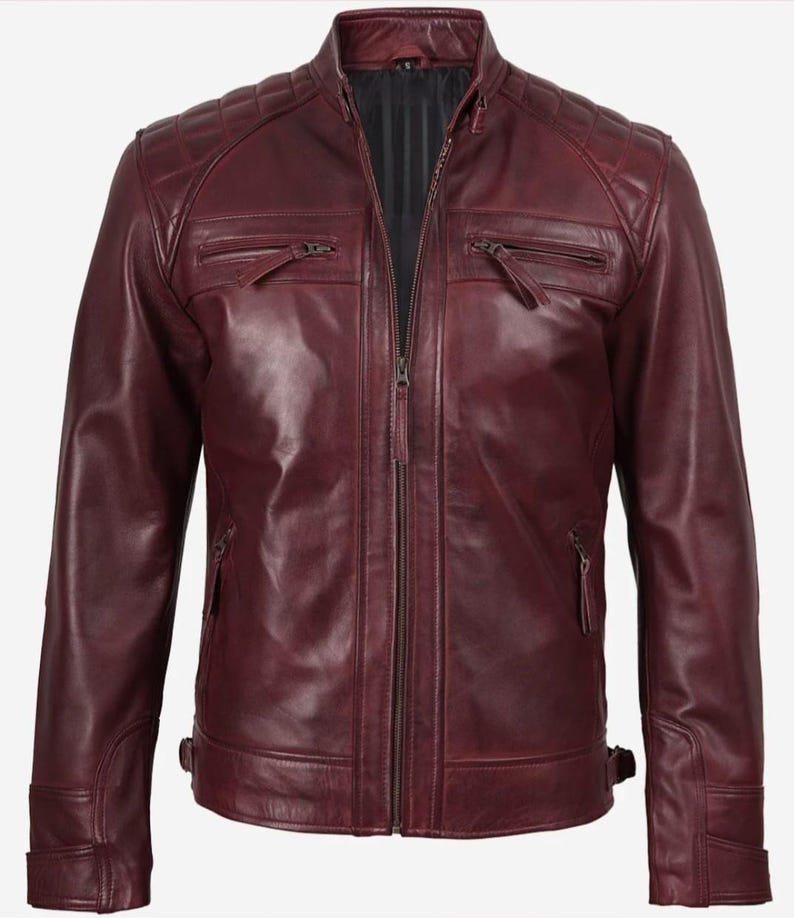 Puede incluir: Chaqueta de cuero burdeos con dise&ntilde;o acolchado en los hombros y cuello alzado. La chaqueta presenta cierre de cremallera frontal, m&uacute;ltiples bolsillos con cremallera y correas laterales ajustables. Un estilo cl&aacute;sico.