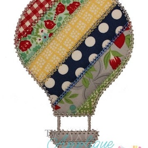 May include: A colorful patchwork hot air balloon with a gray basket. The balloon is made of different fabrics with patterns like polka dots, flowers, and stripes.
