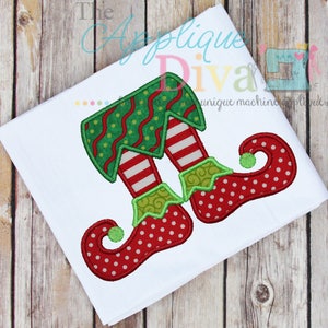 May include: Red and green elf legs with white stripes and red and white polka dot shoes. The shoes have green curled trim and a green ball on the toe.