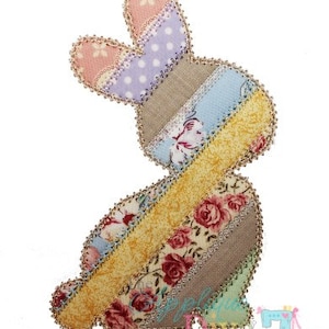 May include: A patchwork bunny applique featuring a range of floral and striped fabrics in shades of pink, blue, yellow, and brown. The bunny is outlined with a beaded trim.