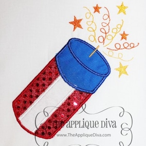 May include: Embroidered design of a red, white, and blue firecracker with sparkling accents and stars. The firecracker has a blue top and is angled to the left, with a lit fuse and starburst effect. The Applique Diva logo is in the bottom right.