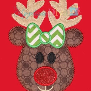 May include: A brown and white reindeer applique with a green and white chevron bow. The reindeer has a red nose with glitter.