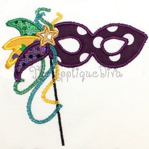 May include: Purple and white polka dot masquerade mask with a green, gold, and purple feather embellishment.