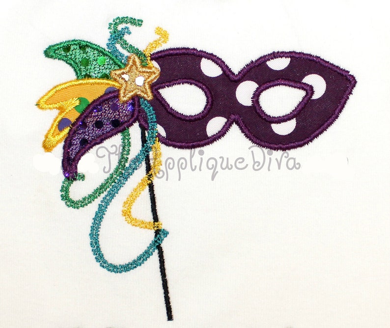 May include: Purple and white polka dot masquerade mask with a green, gold, and purple feather embellishment.