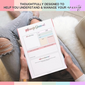 May include: A white Anxiety Journal with pink, blue, and yellow accents is held open. The journal includes prompts for tracking thoughts, feelings, and coping mechanisms. The text at the top reads, "THOUGHTFULLY DESIGNED TO HELP YOU UNDERSTAND & MANAGE YOUR anxiety."