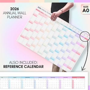 May include: A large, colorful 2026 annual wall planner with a reference calendar. The planner is in the A0 size. The main planner features a grid layout with pastel color-coded months. The text "2026 ANNUAL WALL PLANNER" is displayed at the top.