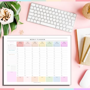 May include: A weekly planner with a white background and pastel accents. The planner has sections for each day, with time slots and space for top priorities. A white keyboard, a notebook, and a pen are also visible.