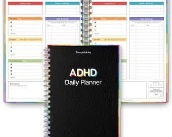 May include: A black ADHD Daily Planner with a spiral binding, open to show colorful interior pages. The cover features the text "ADHD Daily Planner" in white, blue, and red. The planner includes sections for daily schedules, priorities, and self-care.