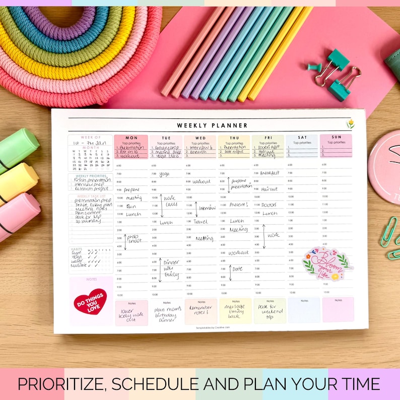 May include: A weekly planner with a pink background, featuring a detailed schedule layout. The planner includes sections for each day of the week, with space for notes and appointments. Colourful pencils and highlighters are arranged around the planner.