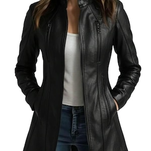 May include: Black leather jacket with a stand-up collar, zip-up front, and multiple zippered pockets. The jacket has a tailored fit and a mid-thigh length. The model is wearing blue jeans and a white top.